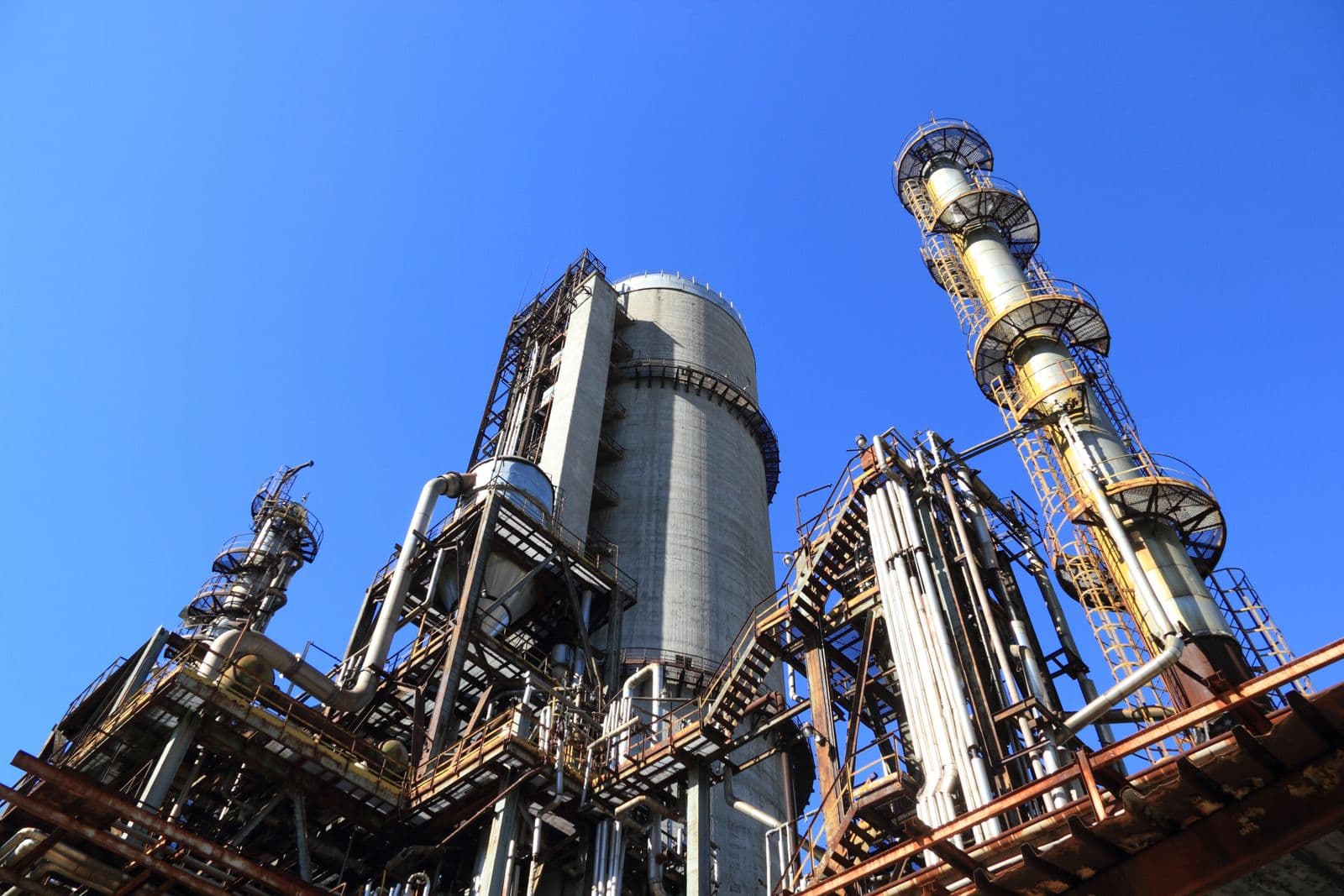 Industrial piping and tanks at a processing facility.